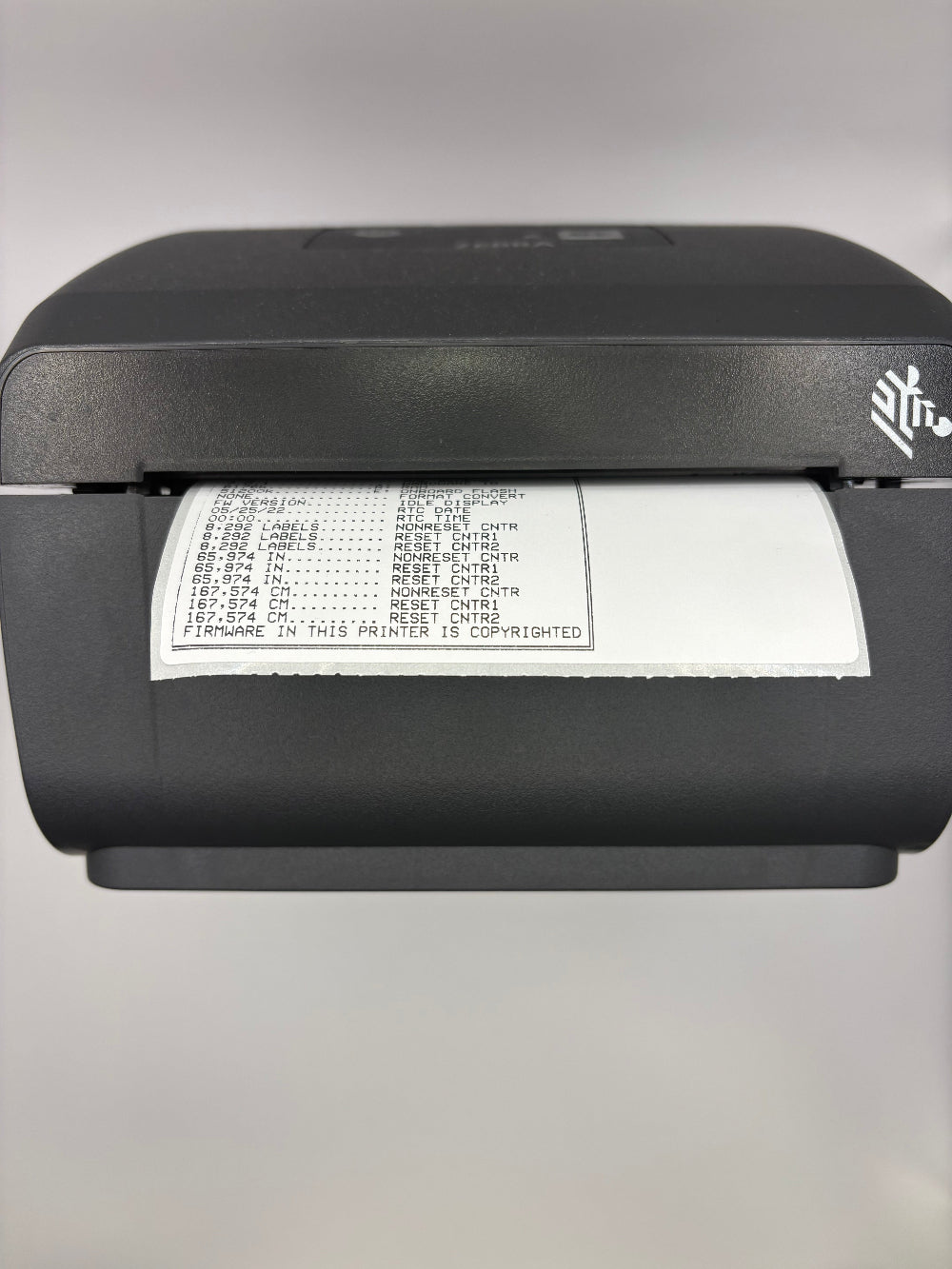 Front view of a Zebra ZD230 label printer showing configuration printout