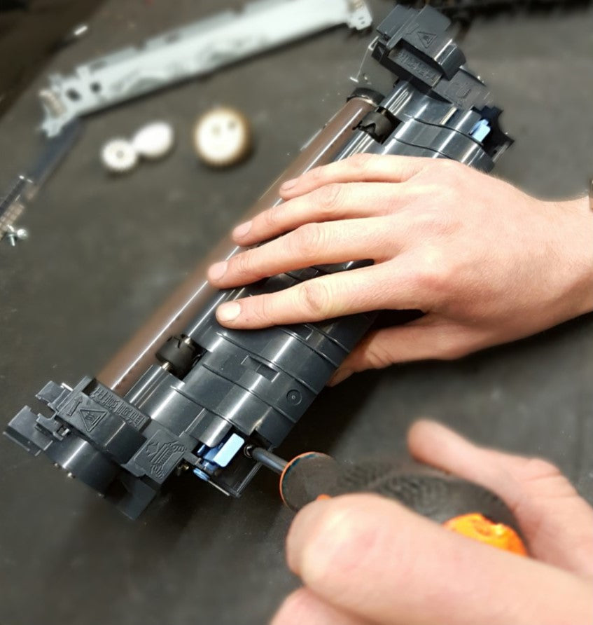 CDS engineer repairing a printer fuser unit